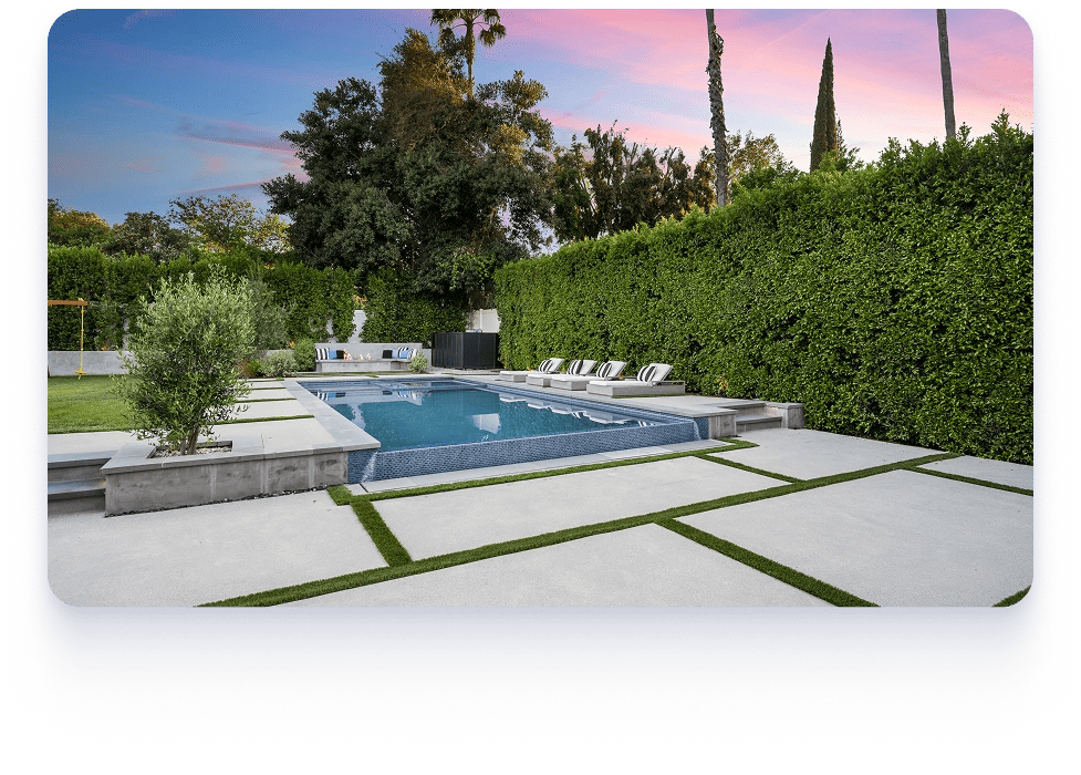 A renovated Texas backyard featuring a swimming pool, patio, and well-maintained lawn.
