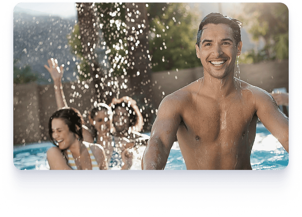 A man, woman, and child play in a pool, showcasing a joyful family moment in a flexible pool construction setting.