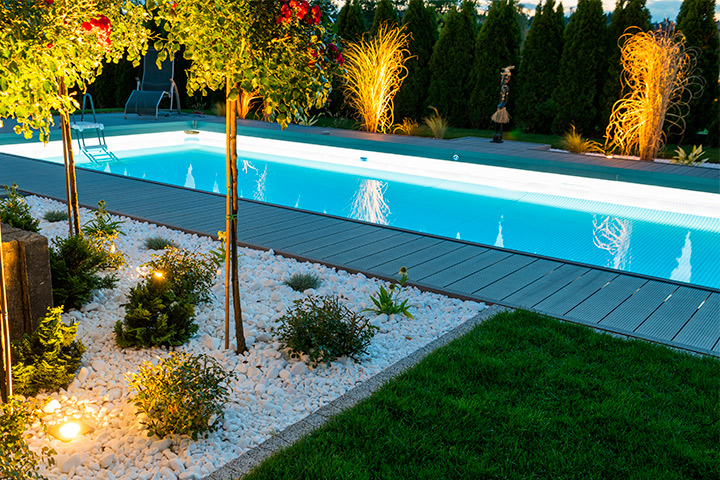 A pool surrounded by a glowing LED-lit area, highlighting essential features for swimming pools in Austin and Houston.